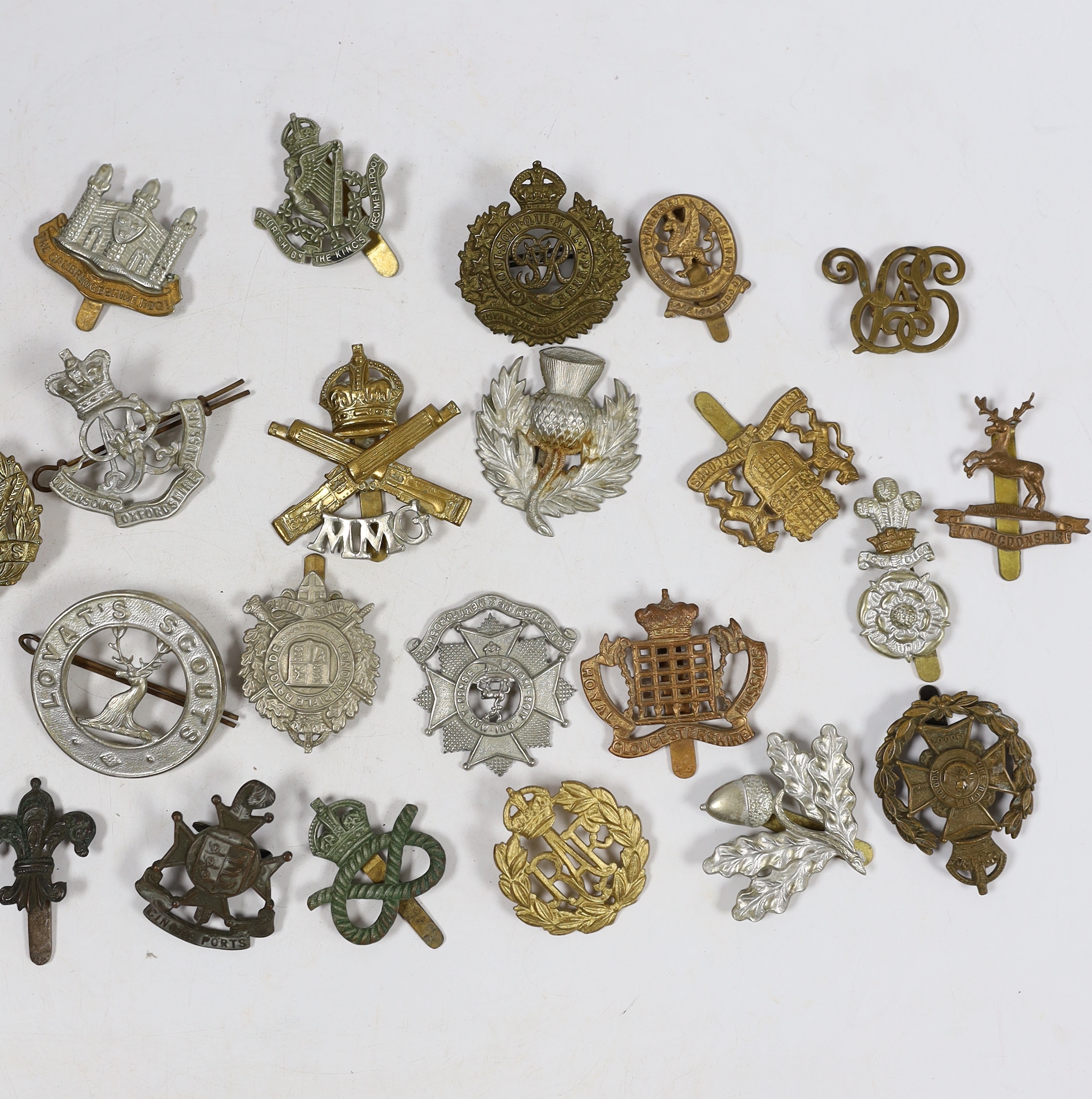 Thirty military cap badges including Royal Canadian Engineers, Royal Gloucestershire Hussars, the Robin Hoods, RAF, the Cambridgeshire Regiment, Tank Corps, Huntingdonshire, Westminster Dragoons, Cinque Ports, Derbyshire